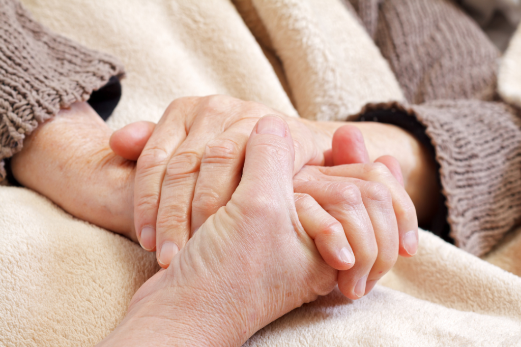nurse holding elderly hands